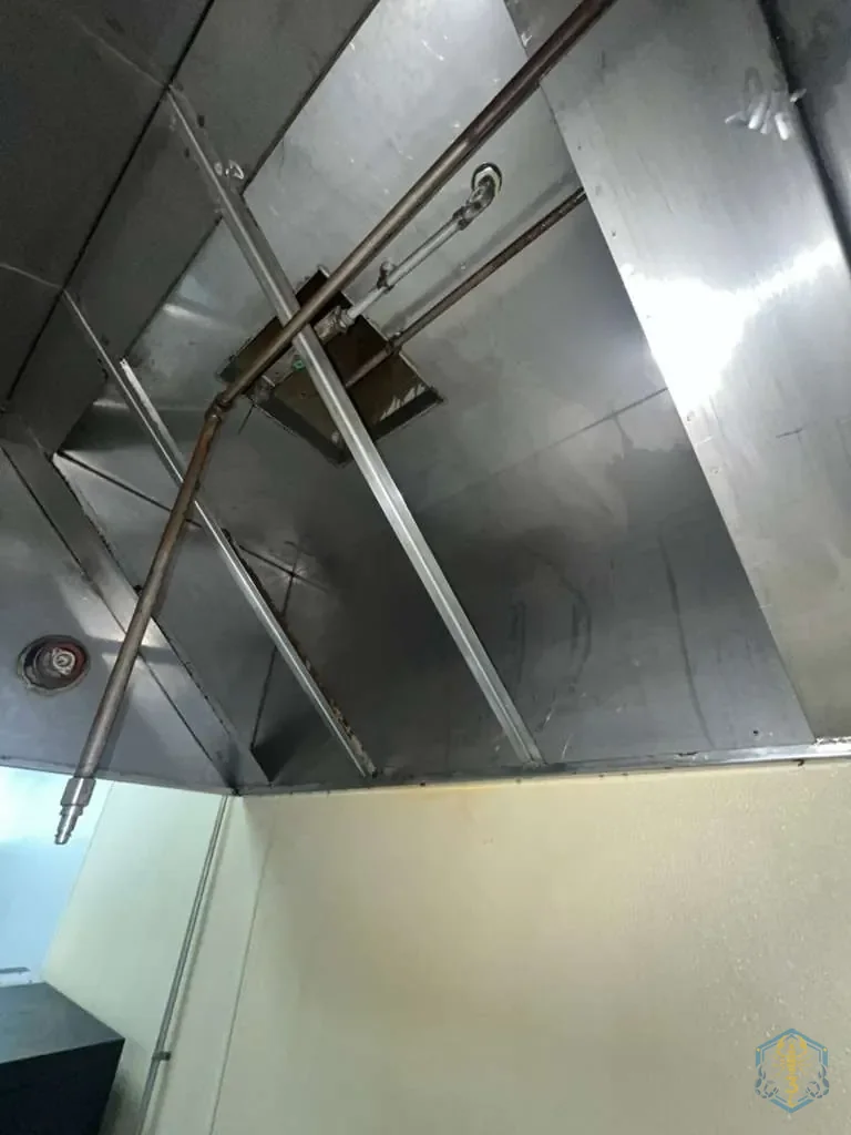 Exterior of the hood and its support brackets after cleaning, wiped down and dry.