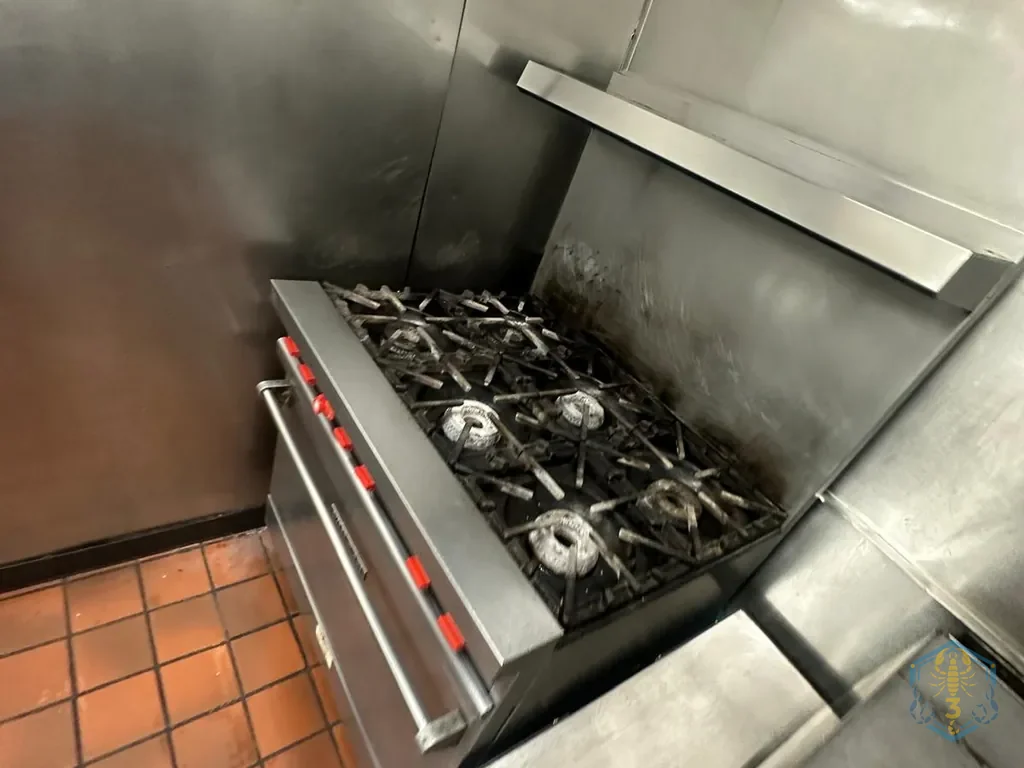 The same range after cleaning, grates back in place and the back splash wiped down.
